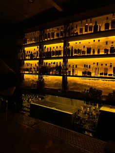 a dimly lit bar with liquor bottles on the shelves