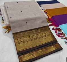 This saree comes with beautiful kanchivaram style gold/copper zari woven borders on chettinad cotton with body woven buttas. Pallu has simple and elegant stripes with buttas. These sarees are a fusion of Chettinad Cottons sarees with Kanchivaram style copper/gold zari woven borders. Running Blouse (5.5 + 0.7 m) Fall and pico - not done Brown Chanderi Handloom Traditional Wear, Brown Handloom Dupatta For Diwali, Brown Traditional Wear With Cutdana For Puja, Festive Brown Cotton Traditional Wear, Brown Handloom Saree For Puja, Brown Handloom Dupatta For Puja, Handloom Brown Dupatta For Puja, Brown Saree With Zari Weaving For Puja, Brown Pallu Traditional Wear For Puja