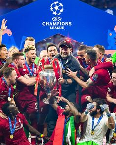 the liverpool united players celebrate with the trophy