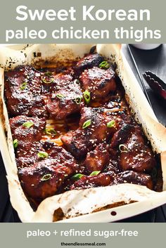 a casserole dish with meat and vegetables in it sitting on a wooden table