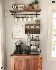 a coffee maker on top of a wooden cabinet