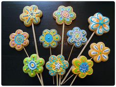 decorated cookies are arranged on top of sticks