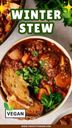 a white bowl filled with stew next to bread and parsley on top of a table