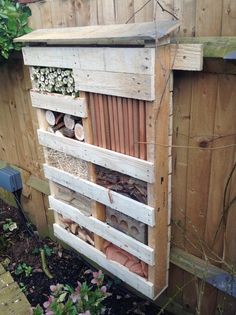 a bee house built into the side of a fence