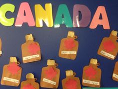 a bulletin board with canada written on it and paper cutouts in the shape of maple leaves