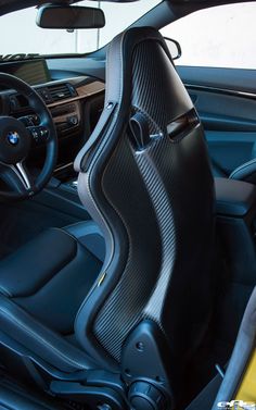 the interior of a car with black leather and grey stitching on the seat covers