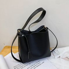 SPECIFICATIONSWeight: 500gTypes of bags: Shoulder & HandbagsStyle: CasualSize: 21x20x11cmShape: BucketPattern Type: panelledOrigin: Mainland ChinaOccasion: VersatileNumber of Handles/Straps: TwoModel Number: SacMain Material: PULining Material: PolyesterItem Type: HandbagsInterior: Interior Slot Pocket,Interior Zipper PocketHardness: SOFTHandbags Type: Shoulder BagsGender: WOMENColor: Black White KhakiClosure Type: HaspBrand Name: BINGYUEXIANG Black Faux Leather Bucket Shoulder Bag, Black Faux Leather Bucket Bag, Black Box Bag With Single Shoulder Strap For Everyday, Black Single Strap Satchel For Shopping, Black Bucket Bag With Single Shoulder Strap For Office, Black Rectangular Satchel With Single Shoulder Strap, Black Handheld Satchel With Single Shoulder Strap, Black Bucket Shoulder Bag With Phone Pocket, Black Shoulder Bag With Single Strap For Daily Use