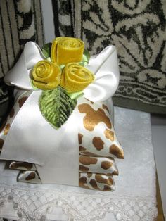 a decorative pillow with yellow roses on it