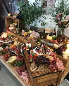 an assortment of meats and cheeses on display at a buffet table in a restaurant