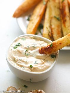 a white plate topped with fries and dip