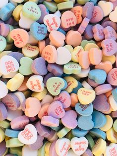 many conversation hearts are scattered on top of each other