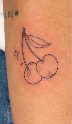 a tattoo on the leg of a woman with a banana and cherries attached to it