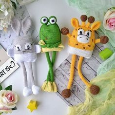 three crocheted stuffed animals sitting next to each other on top of a table