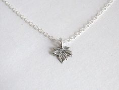 "A precious, small Sterling Silver Maple Leaf hangs from a sturdy yet delicate Sterling Silver chain. - Entire Necklace - .925 Sterling Silver - Maple Leaf - STERLING SILVER - Sterling Silver is a wonderful precious metal that will last for many years to come. Over some time, Sterling Silver will adapt a patina or tarnished look. Wearing your necklace will slow this process. To clean any tarnish that may eventually appear, it is best to use a polishing cloth. Silver creams or liquid cleaners may Minimalist Leaf-shaped Sterling Silver Jewelry, Minimalist Sterling Silver Leaf Jewelry, Sterling Silver Leaf-shaped Jewelry Gift, Everyday Sterling Silver Leaf Jewelry, Dainty Sterling Silver Leaf Jewelry, Sterling Silver Leaf Necklace, Maple Leaf Necklace, Silver Maple Leaf, Gold Leaf Necklace