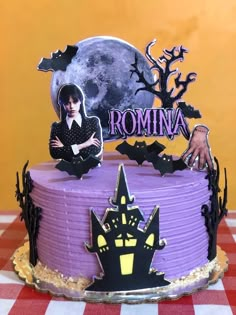 a cake decorated with purple frosting and spooky decorations