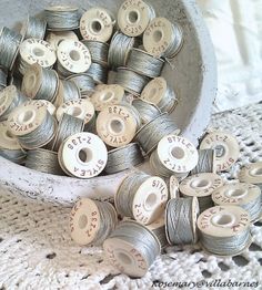 many spools of thread are in a bowl