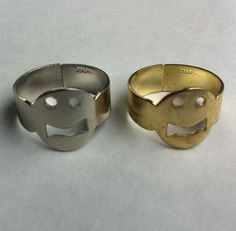 two rings that have been made to look like elephants with mouths and eyes on them