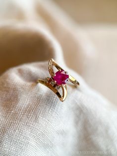 *Asymmetrical Ruby Ring *14k Gold *Ruby, Lab Created *Diamonds, Natural *0.03 carats *H color, SI1 clarity *Ring Size US 6.25 *Circa 1980s ☞ Personalized Ring Sizing is complementary with the purchase of this ring! Simply select the size you would like from the drop down menu, and we will take care of it for you! ☞ Photos are taken in natural California sunshine! Some fine jewelry items may show patina or signs of age or wear in photos. Rest assured, your jewelry will be carefully cleaned and po 14k Gold Ruby Ring For Formal Occasions, Exquisite 14k Gold Ruby Ring For Formal Occasions, Yellow Gold Ruby Rings With Diamond Cut, Timeless 14k Gold Ruby Ring With Prong Setting, Fine Jewelry Ruby Ring With Diamond Cut, Fine Jewelry Yellow Gold Ruby Promise Ring, Fine Jewelry Gemstone Bypass Ring For Formal Occasions, 14k Gold Ruby Ring With Diamond Cut For Gift, Yellow Gold Ruby Promise Ring Fine Jewelry