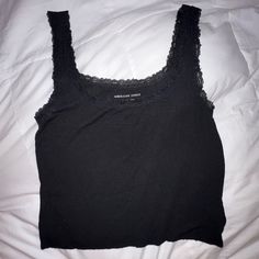 Perfect Condition, Never Worn. Super Soft And Light. Slightly Cropped. Black Lace Trim Including The Straps. Ask Any Questions! 97% Viscose, 3% Elastane Fitted Black Tank Top With Lace Trim, Black Sleeveless Crop Top With Lace Trim, Casual Black Tank Top With Lace Trim, Casual Black Lace Trim Tank Top, Lace Trim Tank Top, Black Lace Trim, Black Lace, Lace Trim, Rib Knit