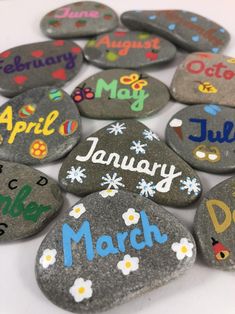 some rocks that have been painted with the names of each month and months on them