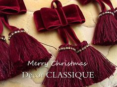 three red christmas decorations on a white surface with the words merry christmas decor classique