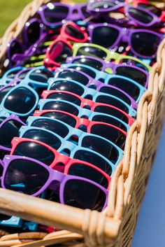 a basket filled with lots of sunglasses on top of a table