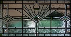 a stained glass window with geometric designs on it