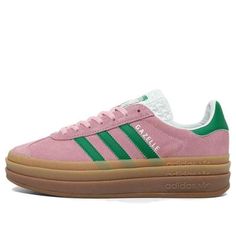 The adidas Gazelle Bold True Pink features a vibrant watermelon-inspired colorway with a gum rubber platform. The True Pink suede upper boasts a tonal T-shaped toebox, while green 3-Stripes and heel tab add a pop of color. The metallic gold 'GAZELLE' lettering pays homage to its 1970s heritage. Green And Pink Sambas, Pink And Green Gazelles, Pink And Green Adidas, Cute Cheap Shoes, Platform Gazelle, Pastel Vans, Adidas Gazelle Black, Adidas Gazelle Bold, Gazelle Bold