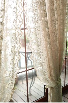 an open window with sheer curtains on it