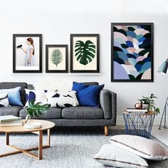 a living room filled with furniture and pictures on the wall above it's coffee table