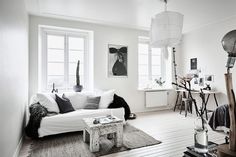 a living room filled with furniture and white walls