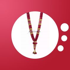 a red and gold beaded necklace on a white circle