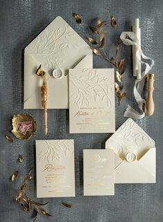 the wedding stationery is laid out and ready for guests to arrive