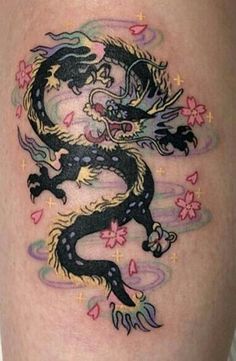 a dragon tattoo is shown on the thigh