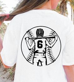 the back of a woman's white shirt with a graphic of a baseball player holding a bat