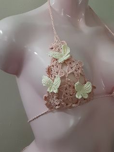 a woman's bra with crocheted butterflies attached to the top and bottom