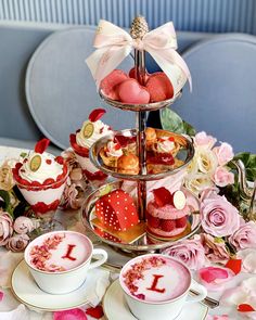 three tiered trays filled with cupcakes and pastries