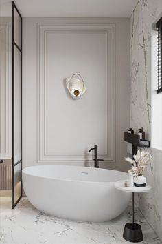 a white bath tub sitting in a bathroom next to a window