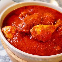 a bowl filled with meatballs and sauce on top of a table