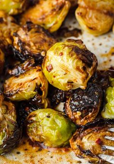 roasted brussel sprouts on a plate with a fork in the middle