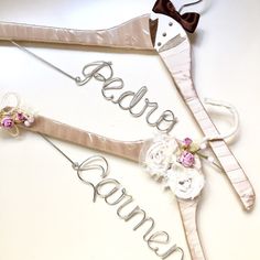 two bridals hangers with the word bride and groom written on them