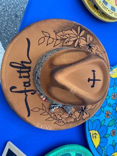 One of a kind bohemian festival fedora hat with handcrafted hand painted, hand burned faith hat.  There is no other hat like this one. Made by local artisan from Belmont nc. Each hat he makes is unique. Belmont Nc, Cowboy Hat Design, Hat Art, Hand Burn, Painted Hats, Boho Hat, Festival Hat, Bohemian Festival, Hat Ideas