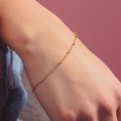 The Satellite Chain Bracelet is a chic and stylish chain, the perfect accessory to take your look to the next level. Crafted with gold or silver dotted bead chain, this dainty gold chain is perfect for easy layering and creates a simple and elegant statement. Rich gold or silver dots complement the design, giving the bracelet added character. Dainty Gold Chain, Golden Jewelry, Month Gifts, Monogram Jewelry, Bead Chain, Gold Bracelet Chain, Chain Link Bracelet, Beaded Chain, Chain Lengths