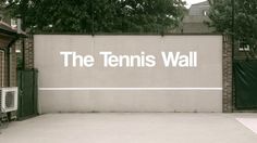 there is a tennis court with the words the tennis wall on it