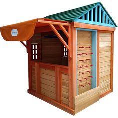 a small wooden building with a green roof and red shoes on the outside, next to an orange awning