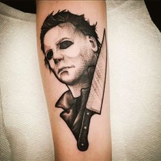 a person with a knife tattoo on their arm and the image of a man holding a knife