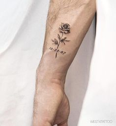 a person's arm with a rose tattoo on it and the word love written in cursive writing