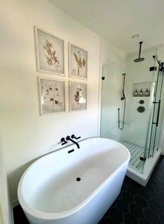 a white bath tub sitting next to a walk in shower