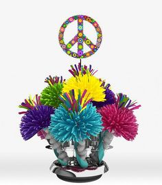 a vase filled with colorful flowers and peace sign