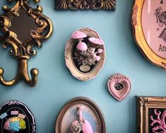 there are many different pictures on the wall with gold trimmings and ornate frames